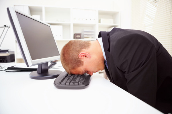 C4NPMK Portrait of a stressed businessman with his forehead resting on the computer keyboard